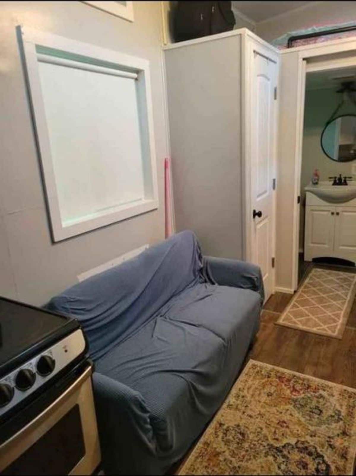 Living area of 20’ Tiny House has a small couch