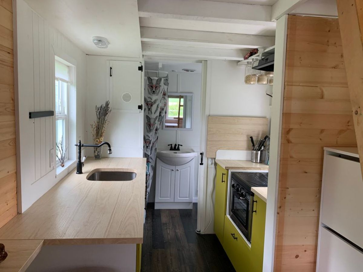 Fully furnished kitchen view and bathroom view of tiny house