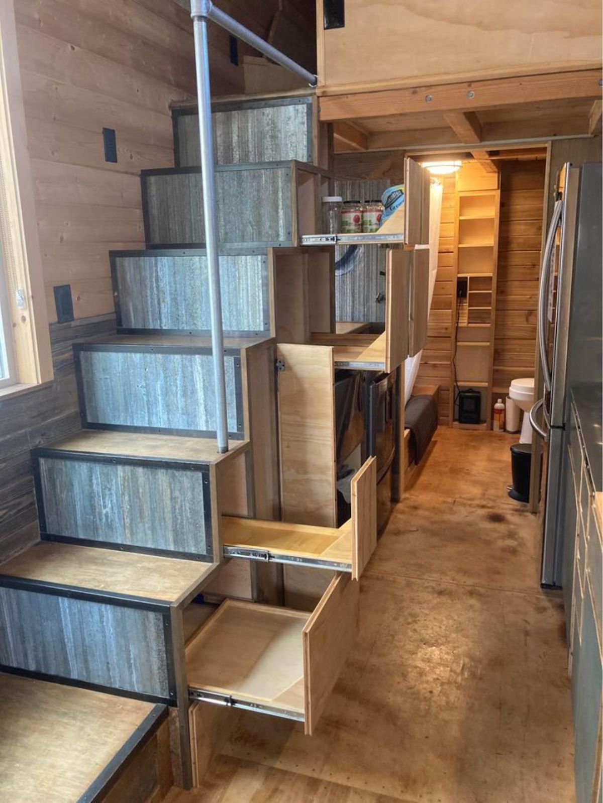 Stairs leading to main bedroom has a lots of storage under each steps plus it has an oven and refrigerator on the opposite side
