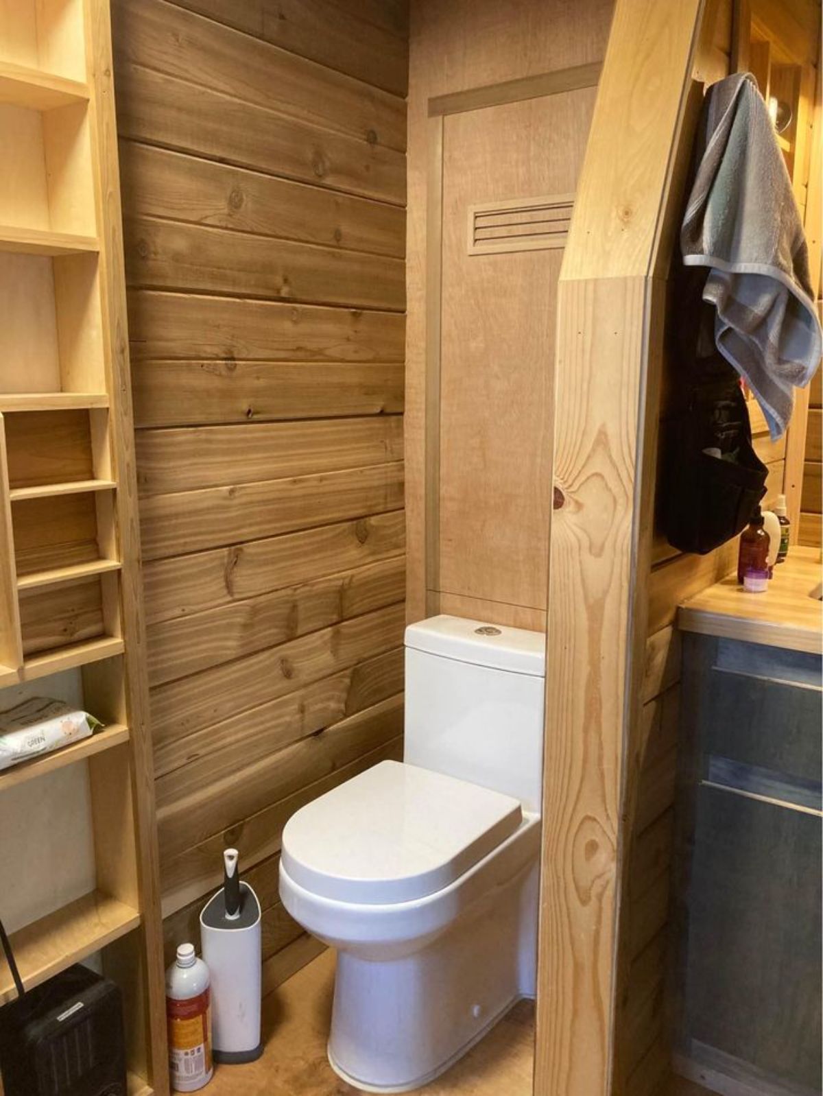 Standard toilet in bathroom of 24’ Rustic Tiny House On Wheels