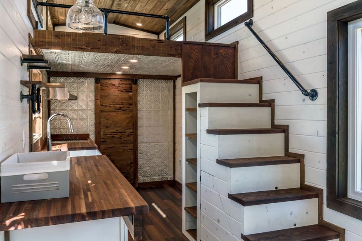 Stairs towards the loft above kitchen of 26' Luxury Tiny Farmhouse