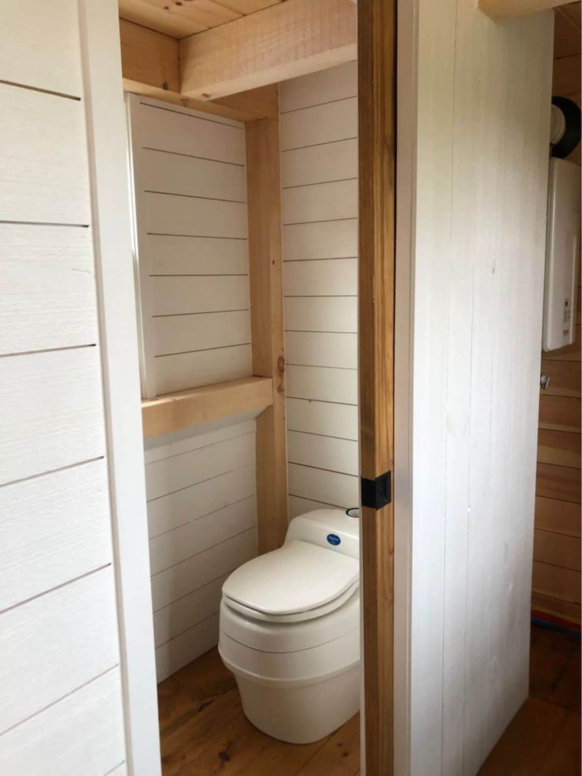 Toilet in bathroom of 26’ Timber Framed Tiny House