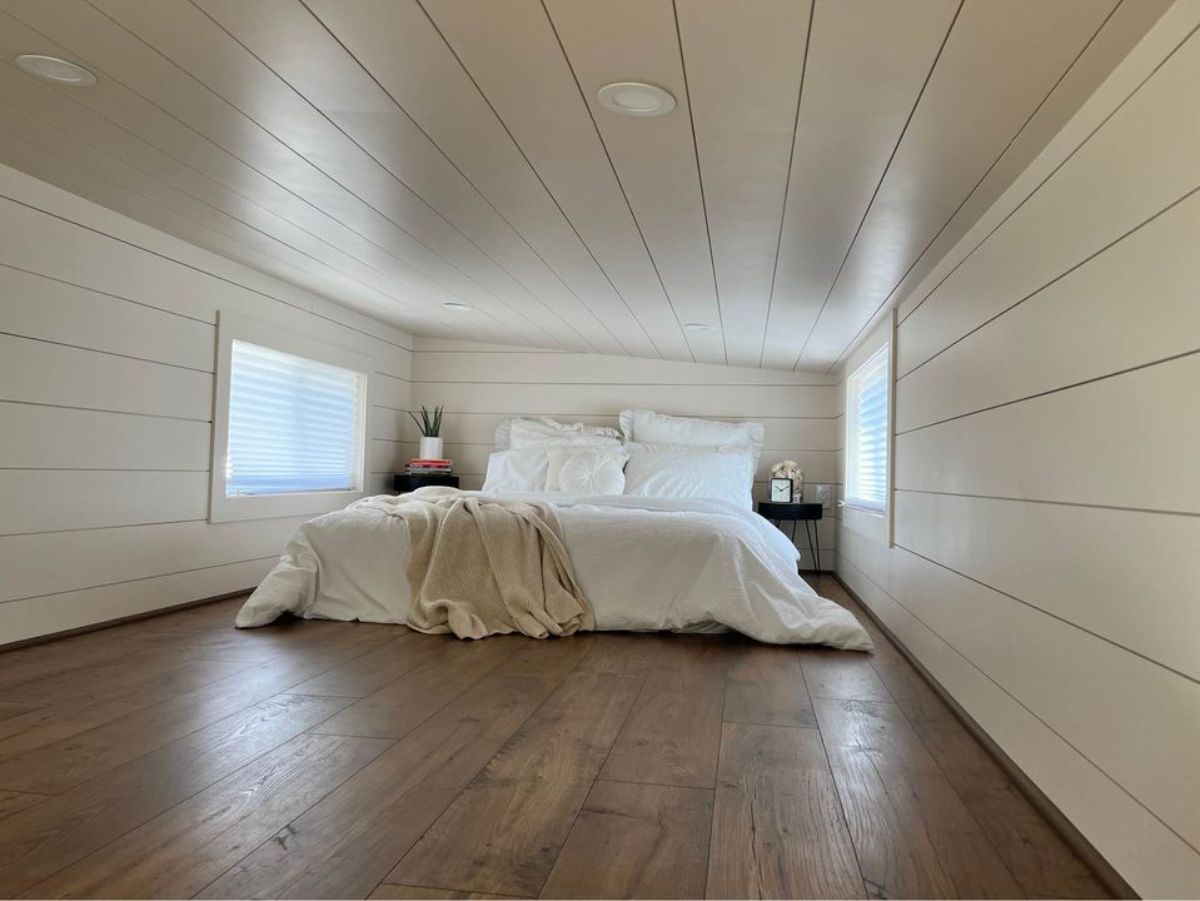Stunning white bedroom has a queen mattress still enough space for many things