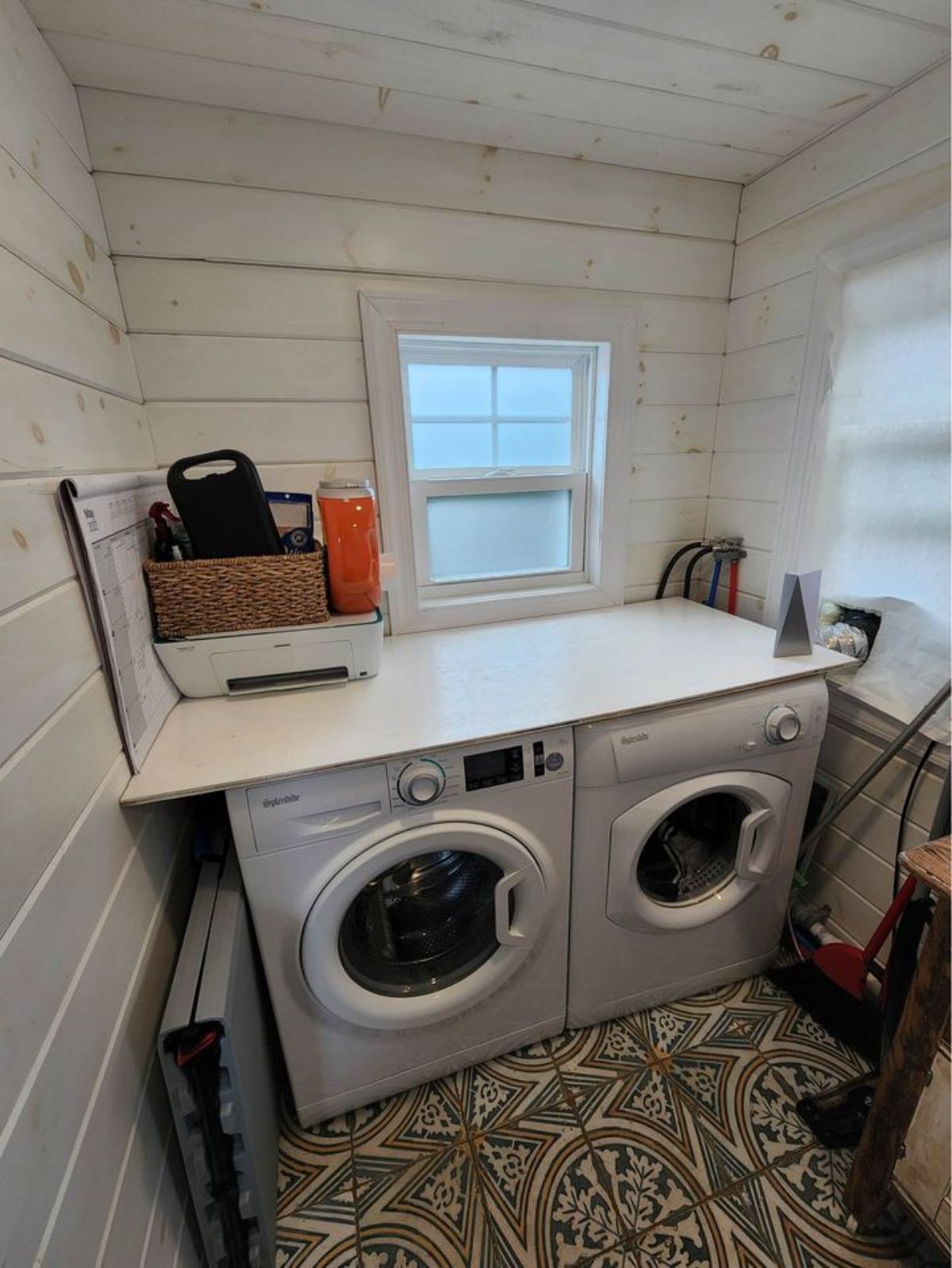 Bathroom area of 450 sf Tiny Home has a washer and dryer unit