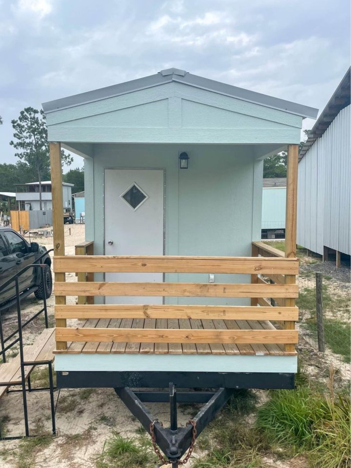 It has a tiny little porch on the exterior of Brand New 35’ Tiny House