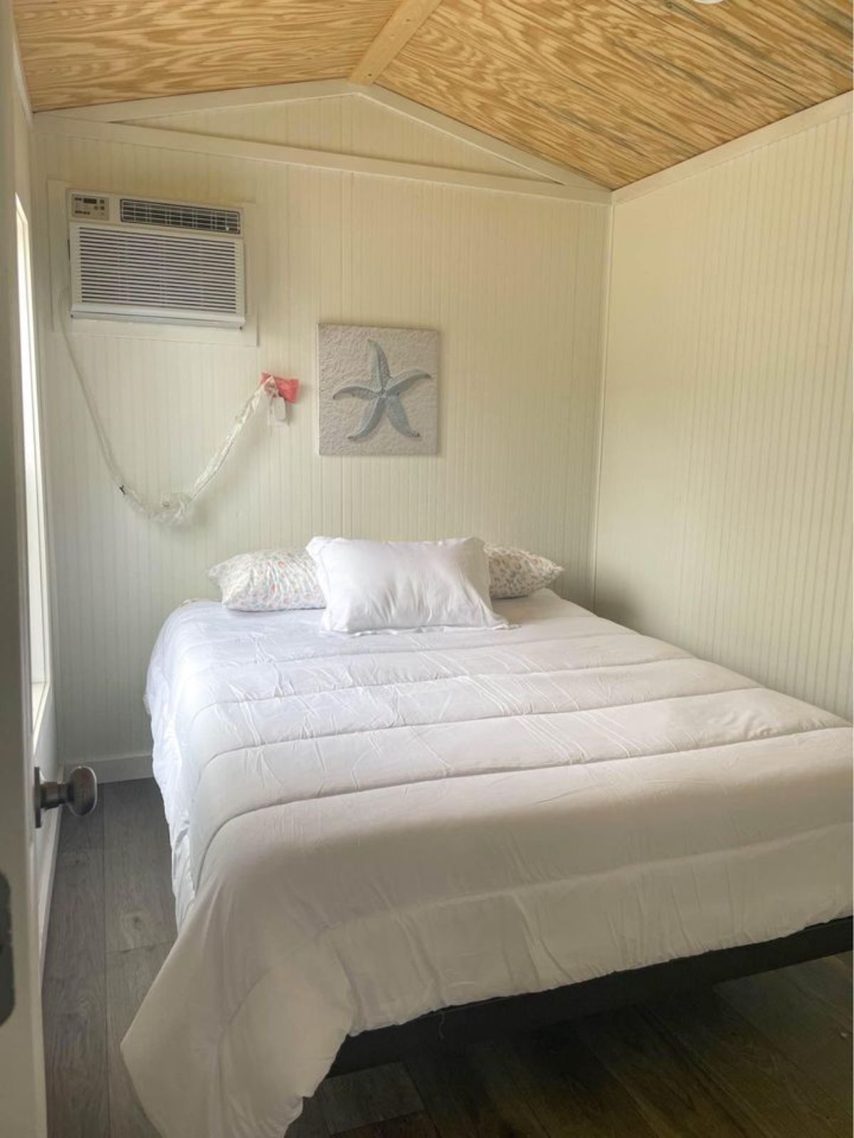 Bedroom of Brand New 35’ Tiny House has a queen bed and air condition unit