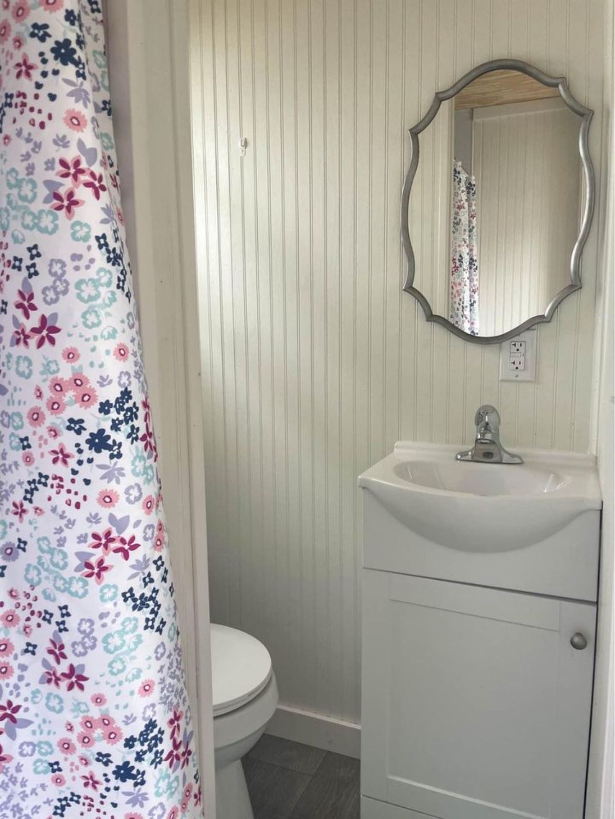 Bathroom of Brand New 35’ Tiny House has a sink with storage and mirror