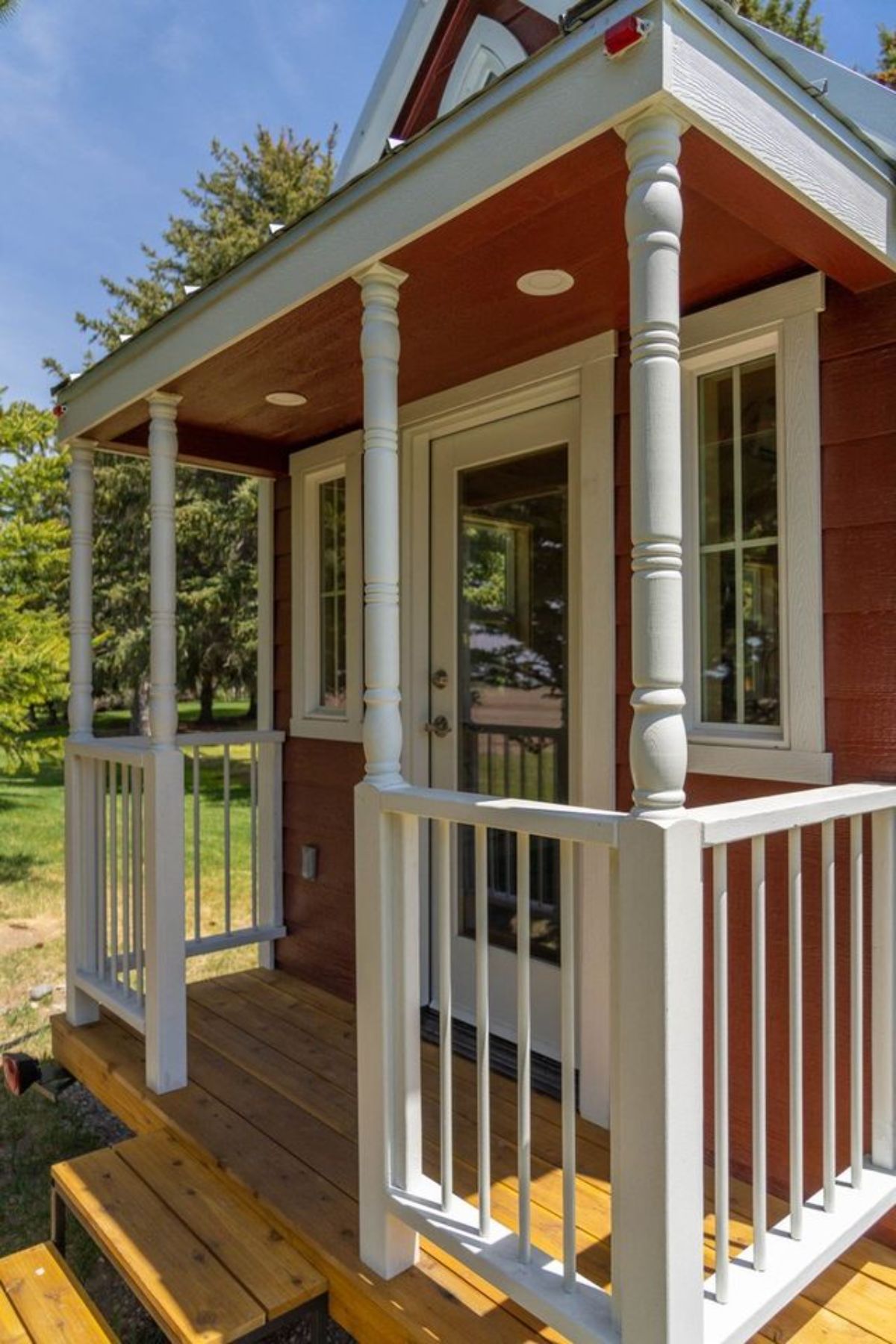 2 Bedroom Tiny House has a little porch outside the main entrance door