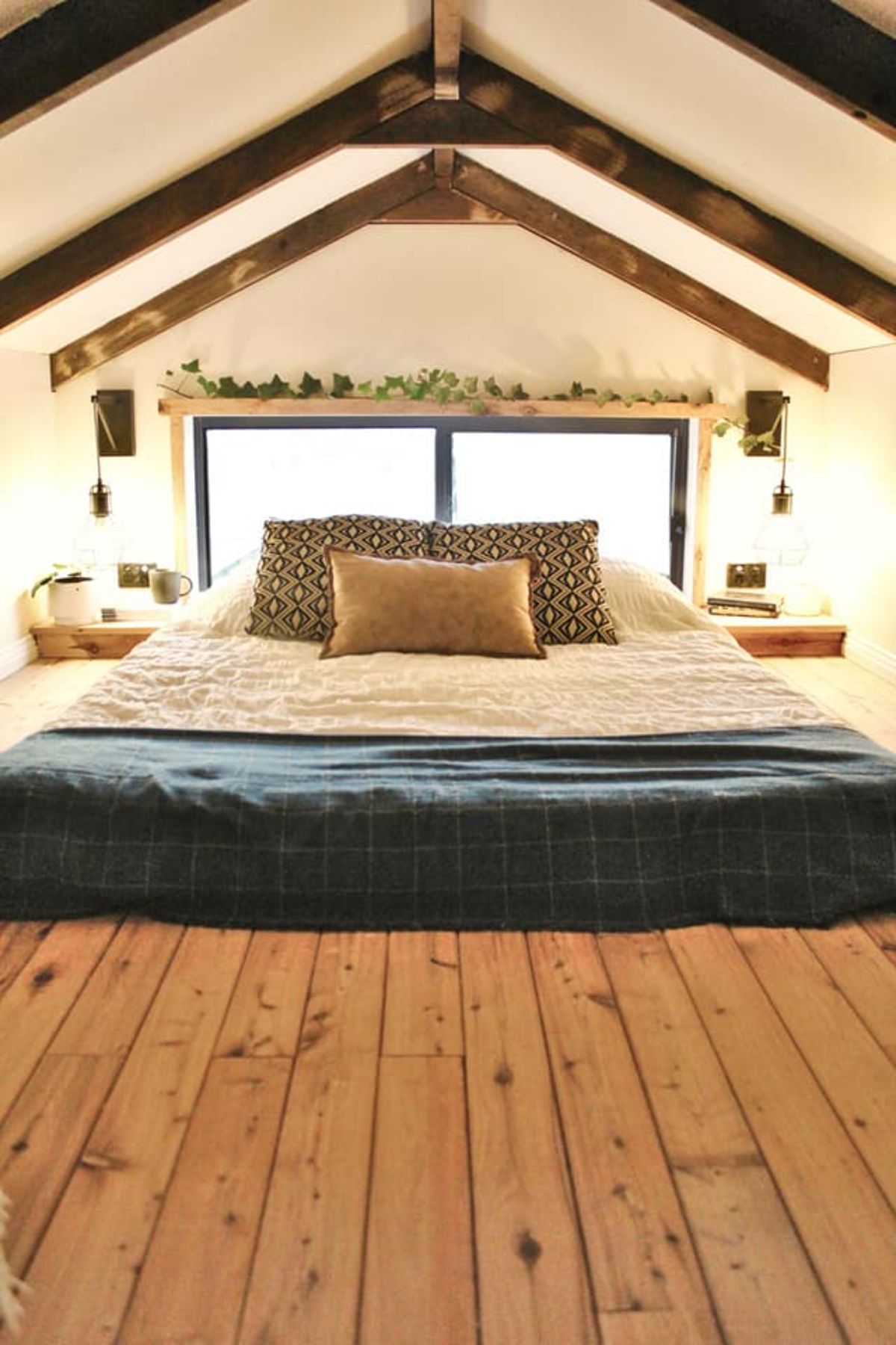 Loft bedroom above the bathroom has a comfortable king size mattress and side table