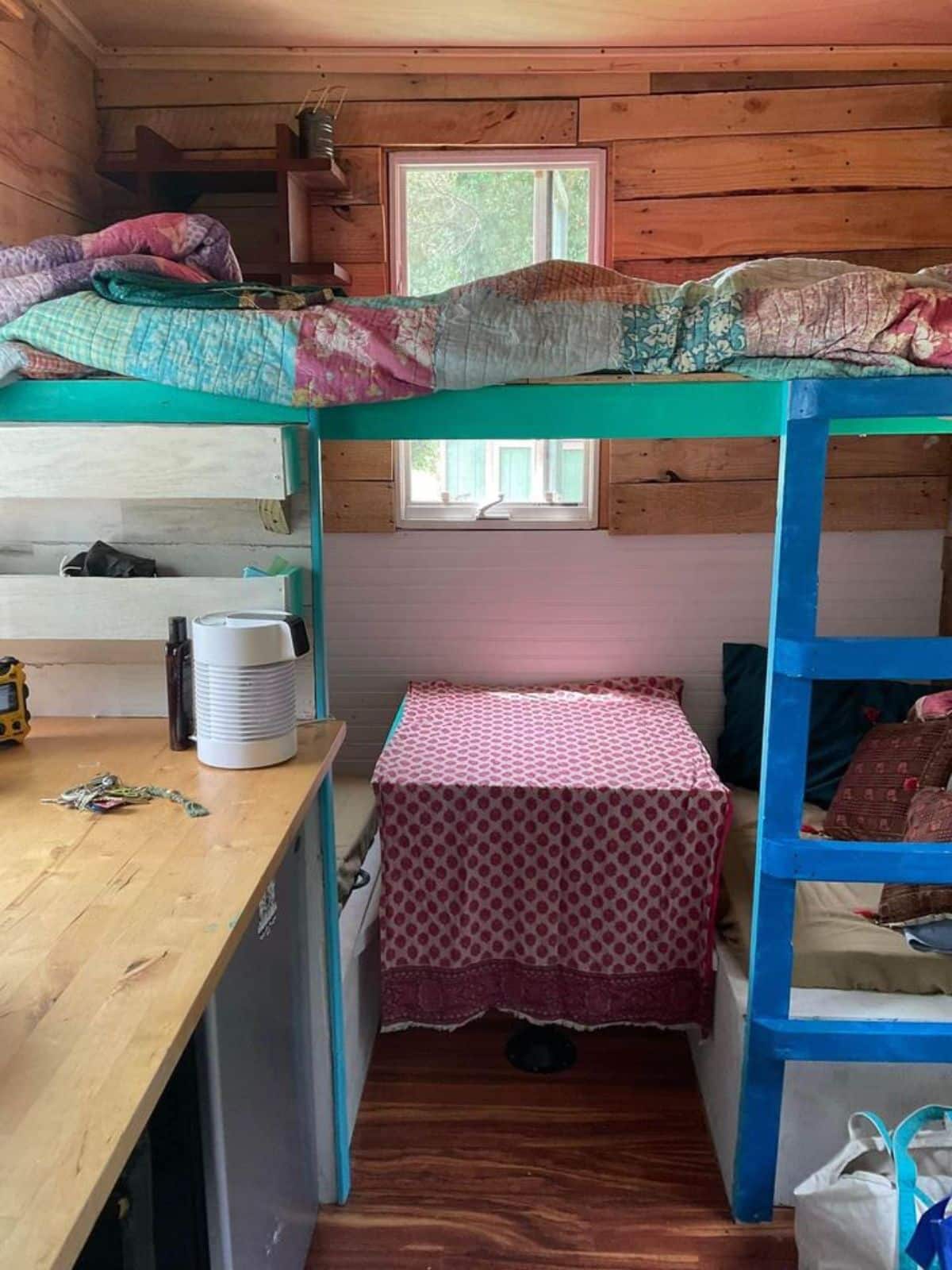 Living area and loft bedroom of 12’ Micro Tiny House