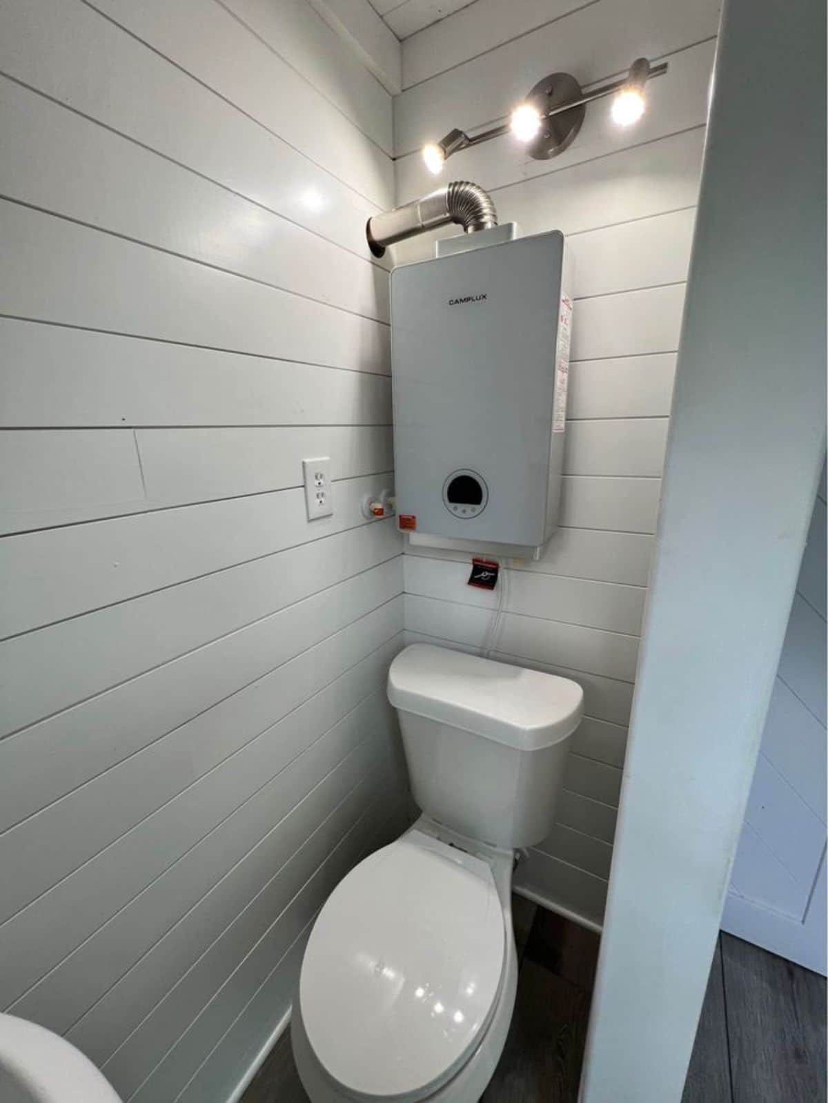 Standard toilet opposite to sink in bathroom