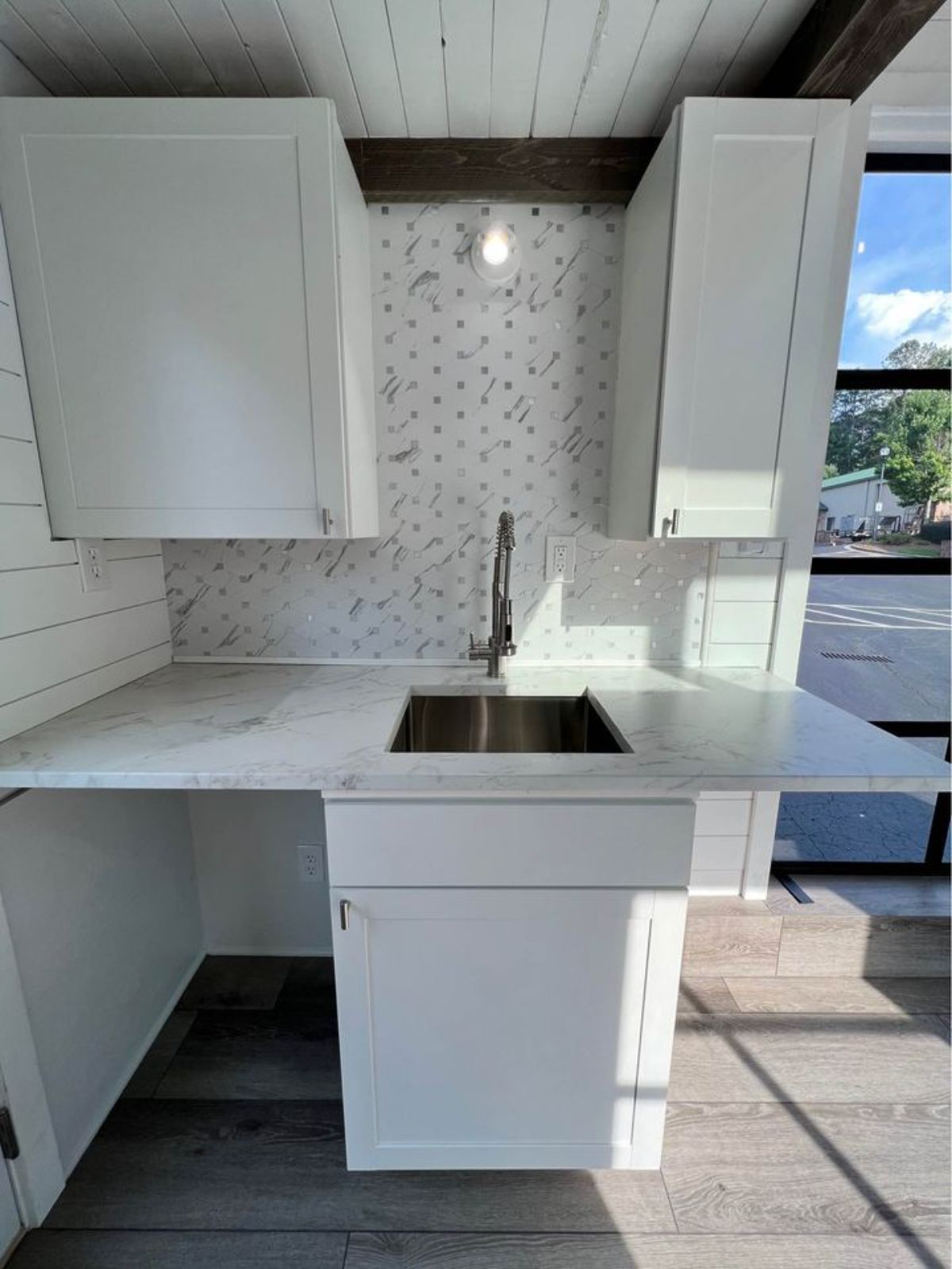 Countertop and sink with storage on other side which can be used as dining area too