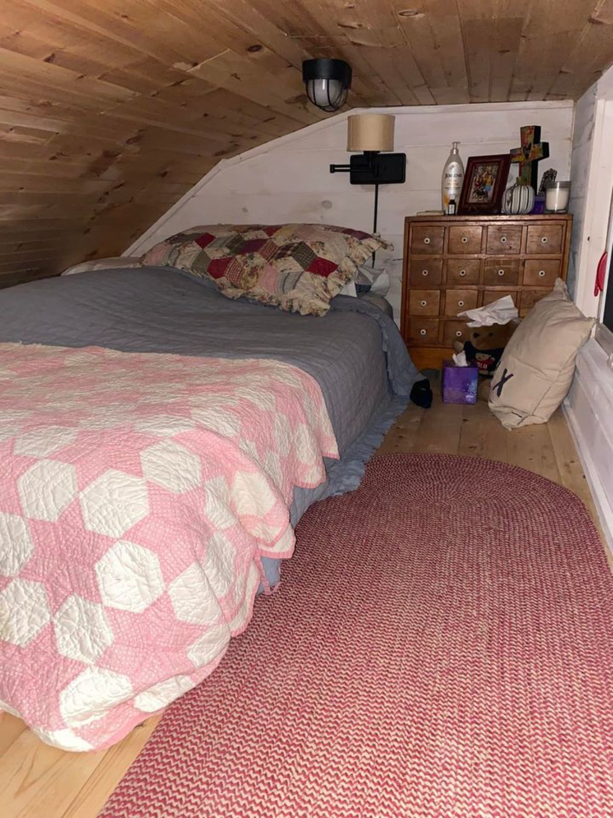 Bedroom of 198 sf Tiny Cottage has a queen bed still left with many space for other things
