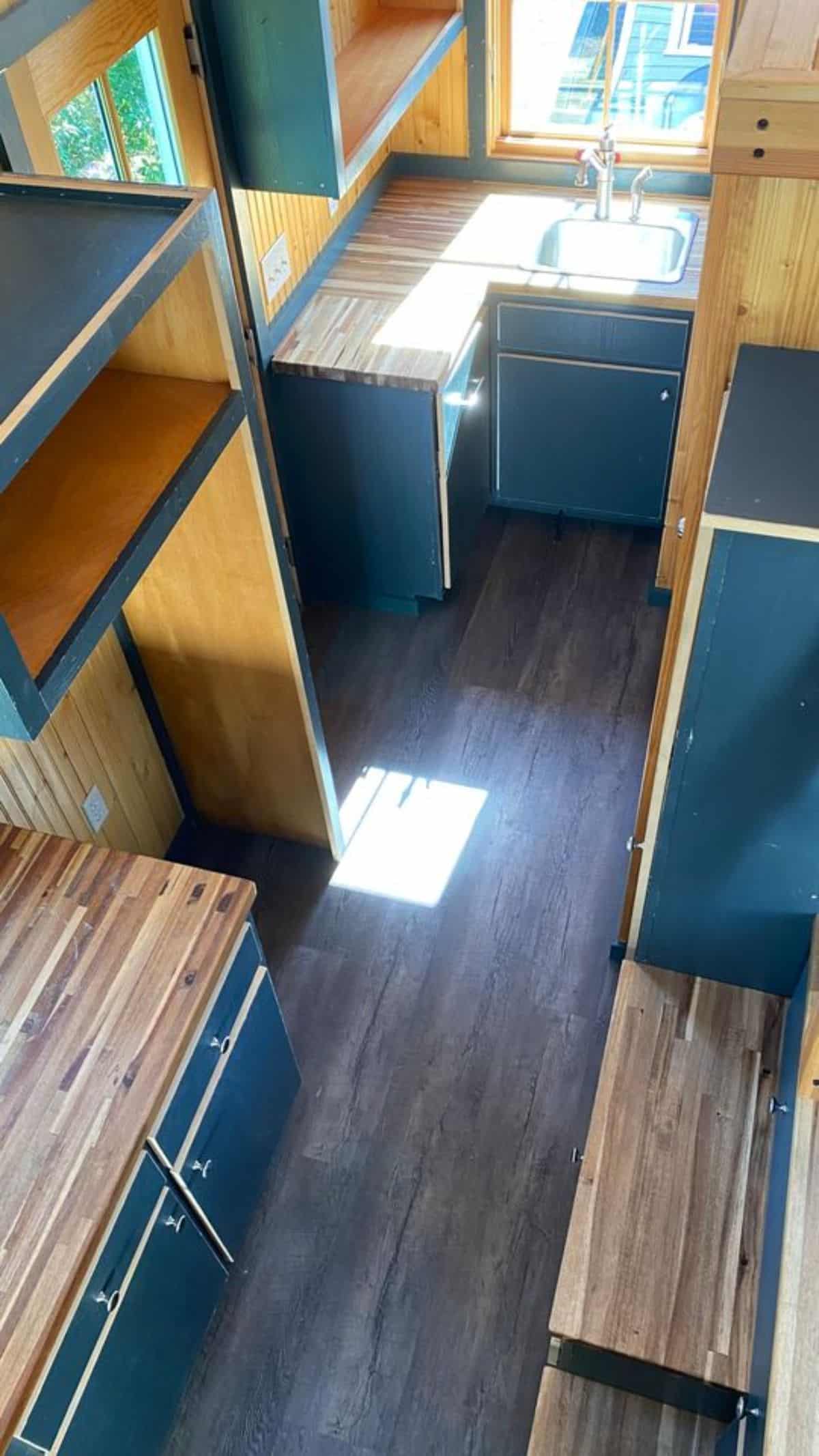 Kitchen area of 20’ Cozy Tiny House is L shaped