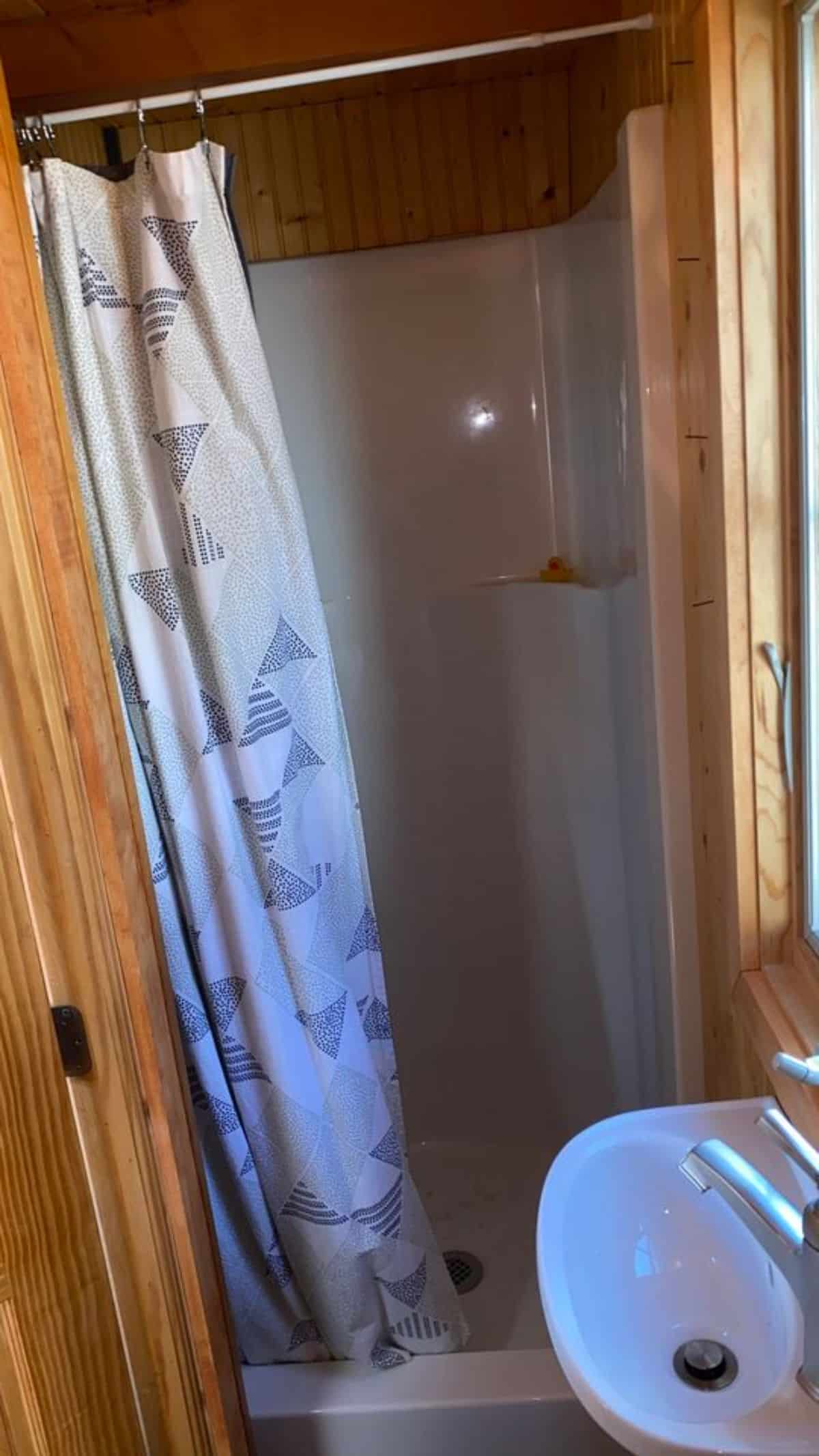 Separate shower area in bathroom of 20’ Cozy Tiny House