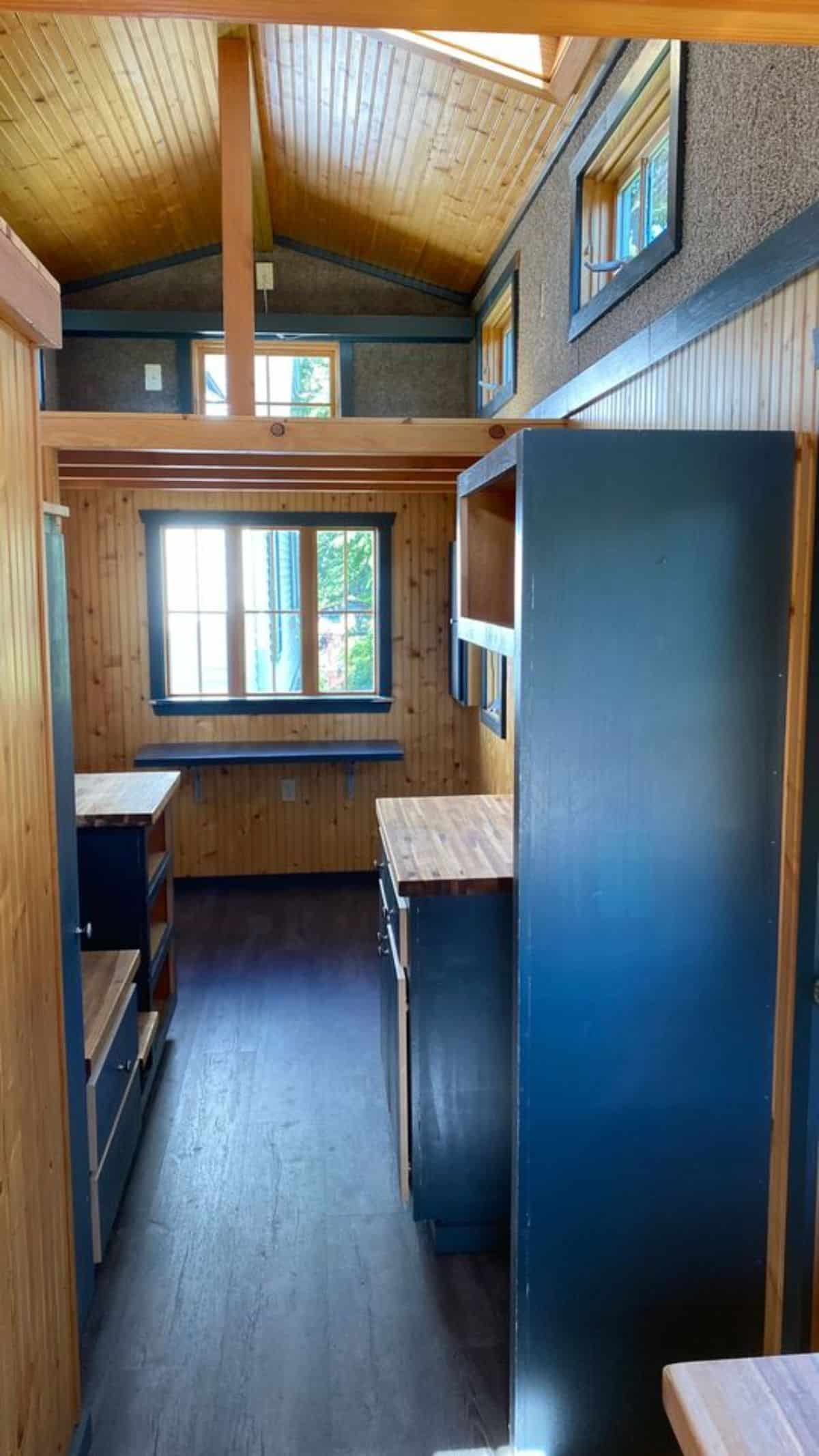Living area of 20’ Cozy Tiny House is small but can accommodate L shaped couch
