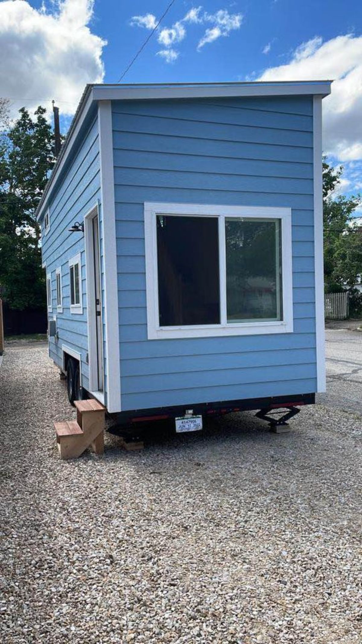 Large windows and blue coloured exteriors of 20’ Tiny House