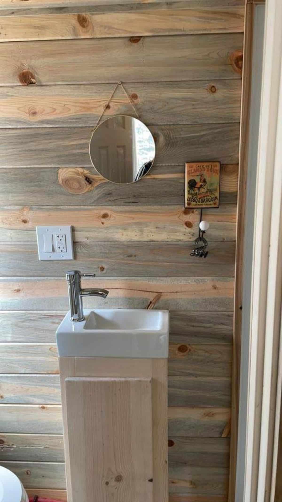 Sink cum vanity and mirror in bathroom of 20’ Tiny House