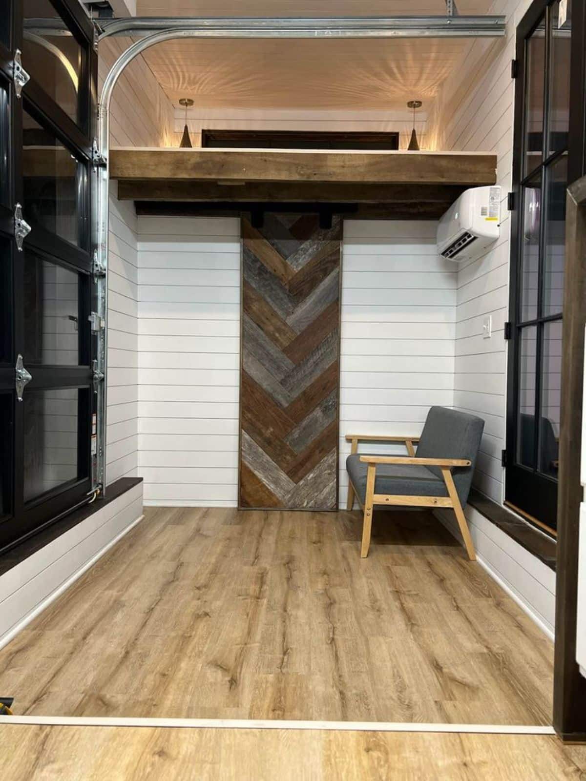 Living area of 22’ Luxury Tiny House has an air condition unit also