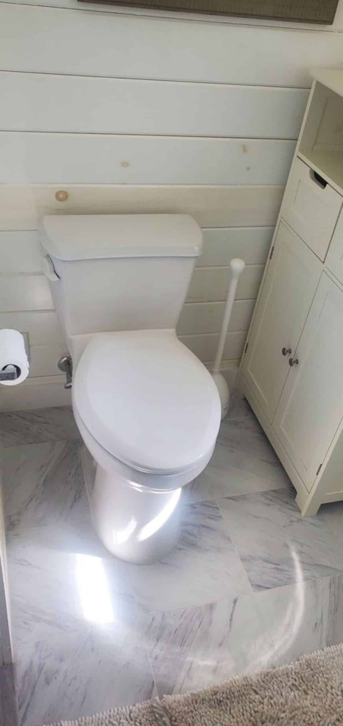 Standard toilet in bathroom of 24’ Tiny House