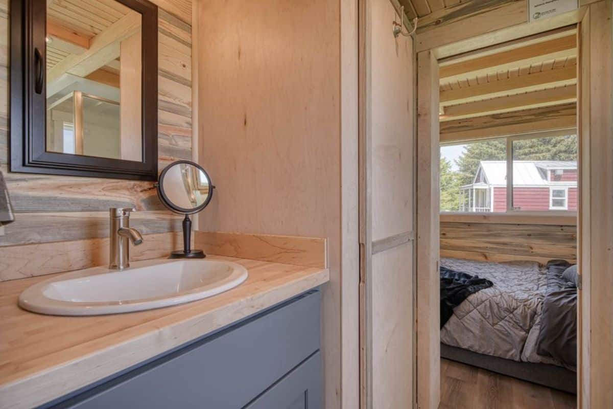Bathroom of 30’ Tiny Home has a sink with vanity on 1 side