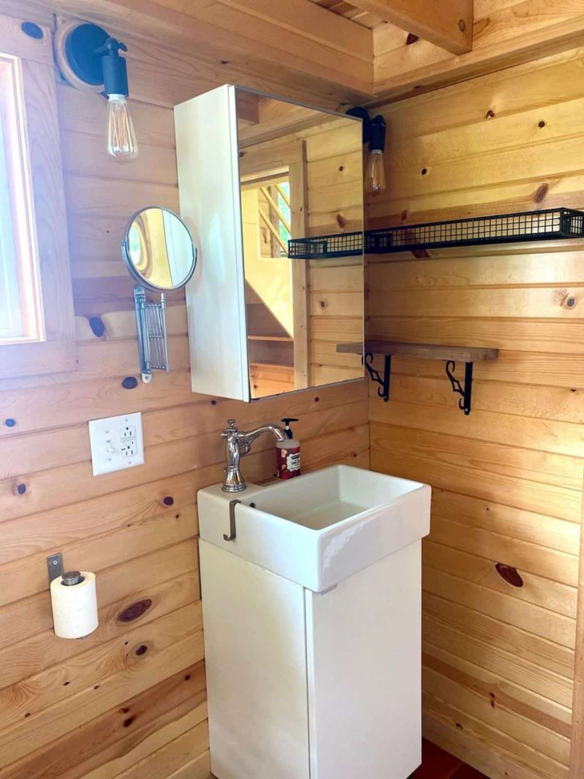 Sink with vanity and mirror in bathroom of 32’ Custom Tiny House