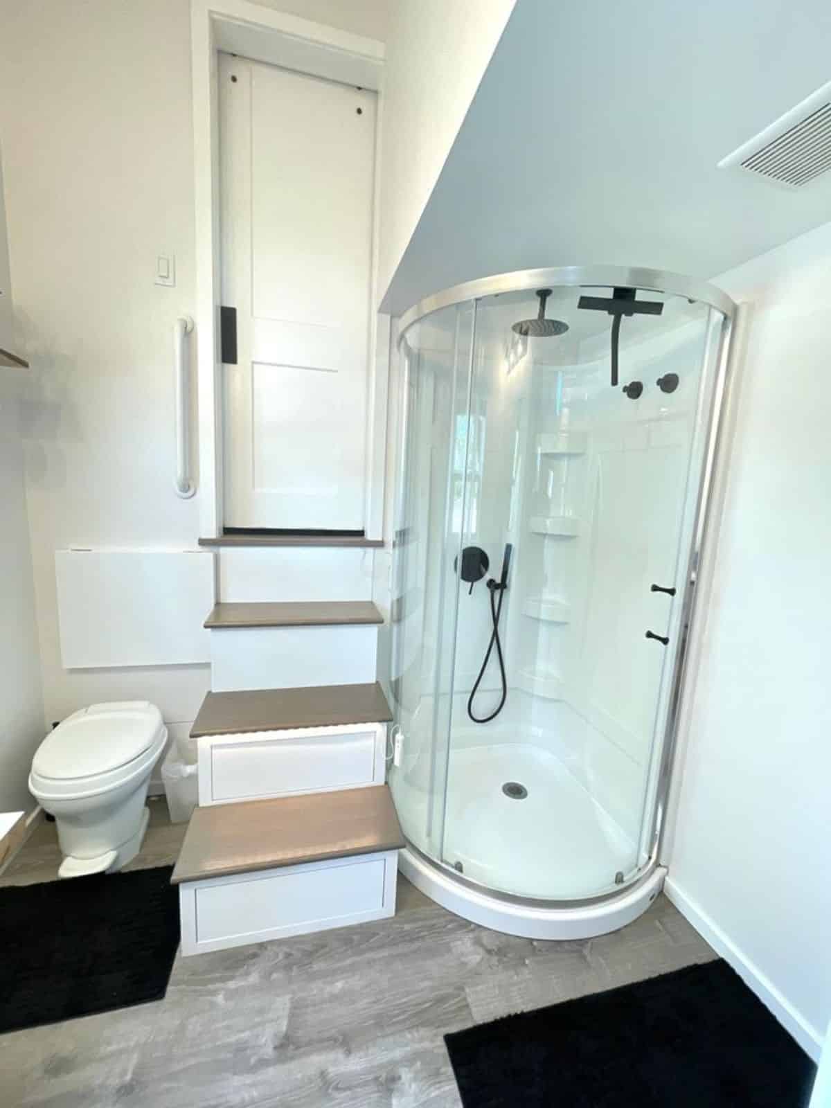 Stunning shower area made of glass plus standard toilet in bathroom