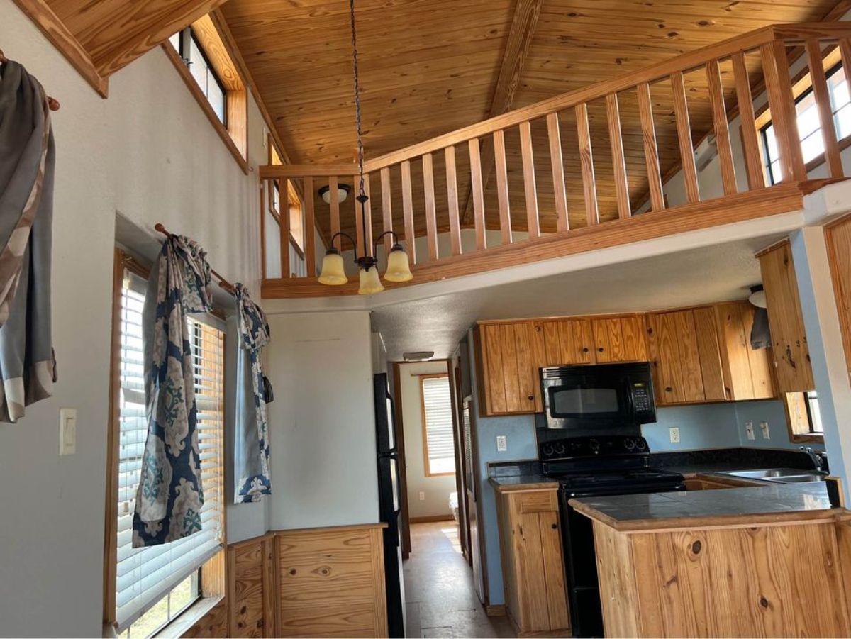 Overall interior of 40’ Tiny Home has kitchen area, living area, bedroom and bathroom
