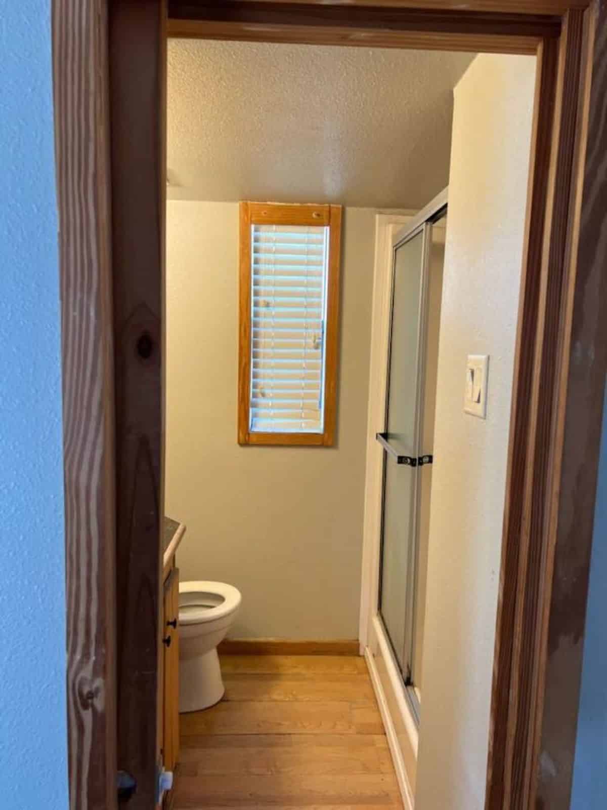 Separate shower area, standard toilet and sink in bathroom of 40’ Tiny Home