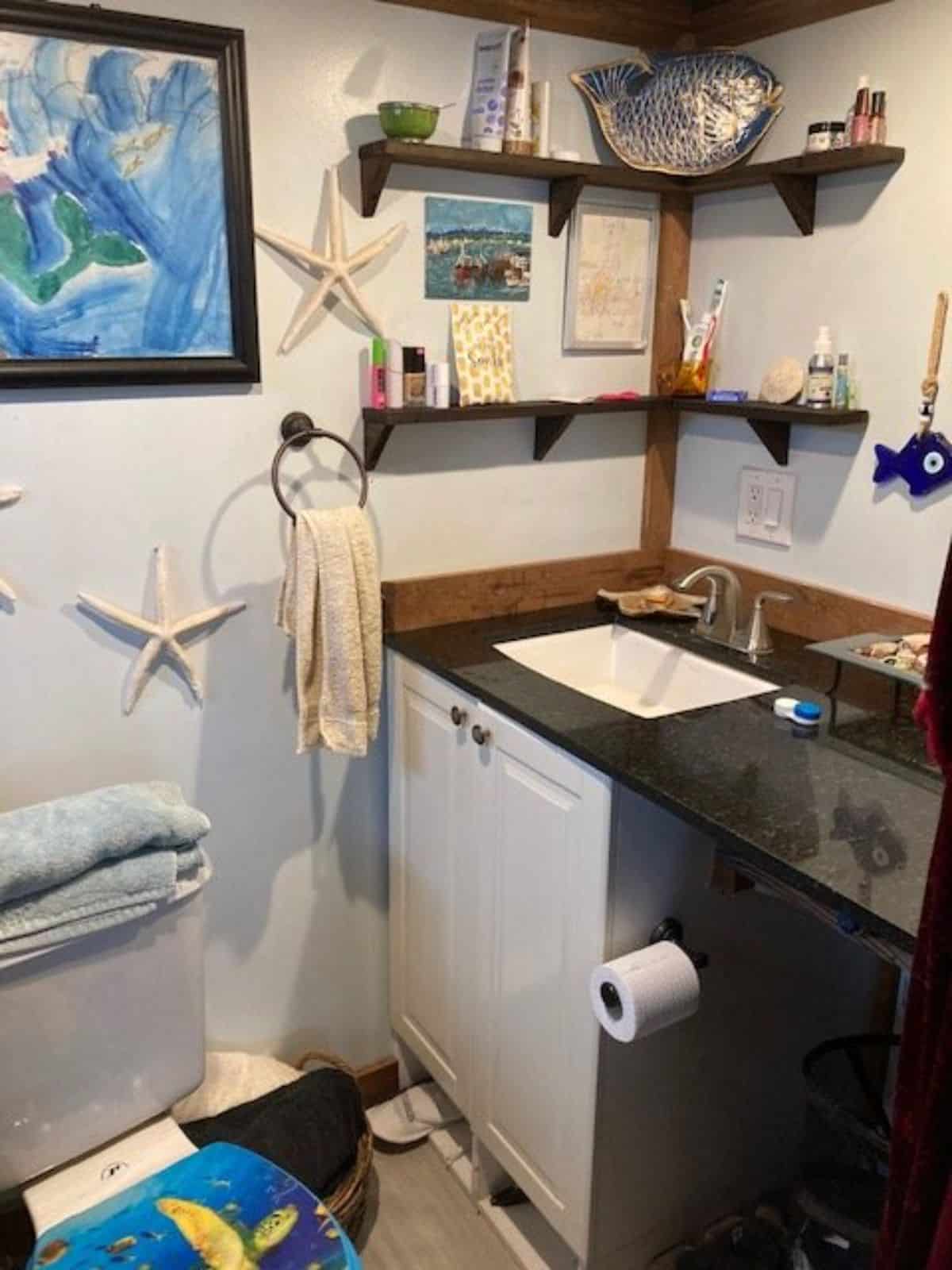 Bathroom has a sink with vanity and mirror