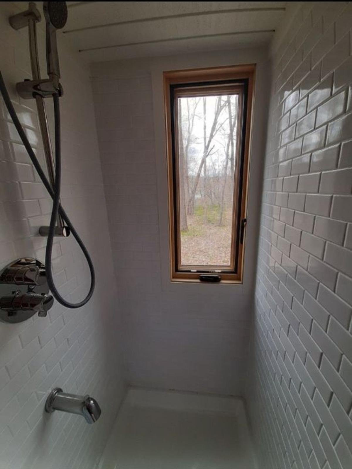 Separate shower area in bathroom of 24’ Custom Built Tiny Home