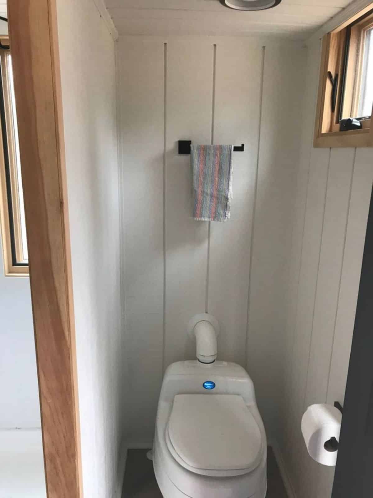 Standard toilet is installed in bathroom of 24’ Custom Built Tiny Home