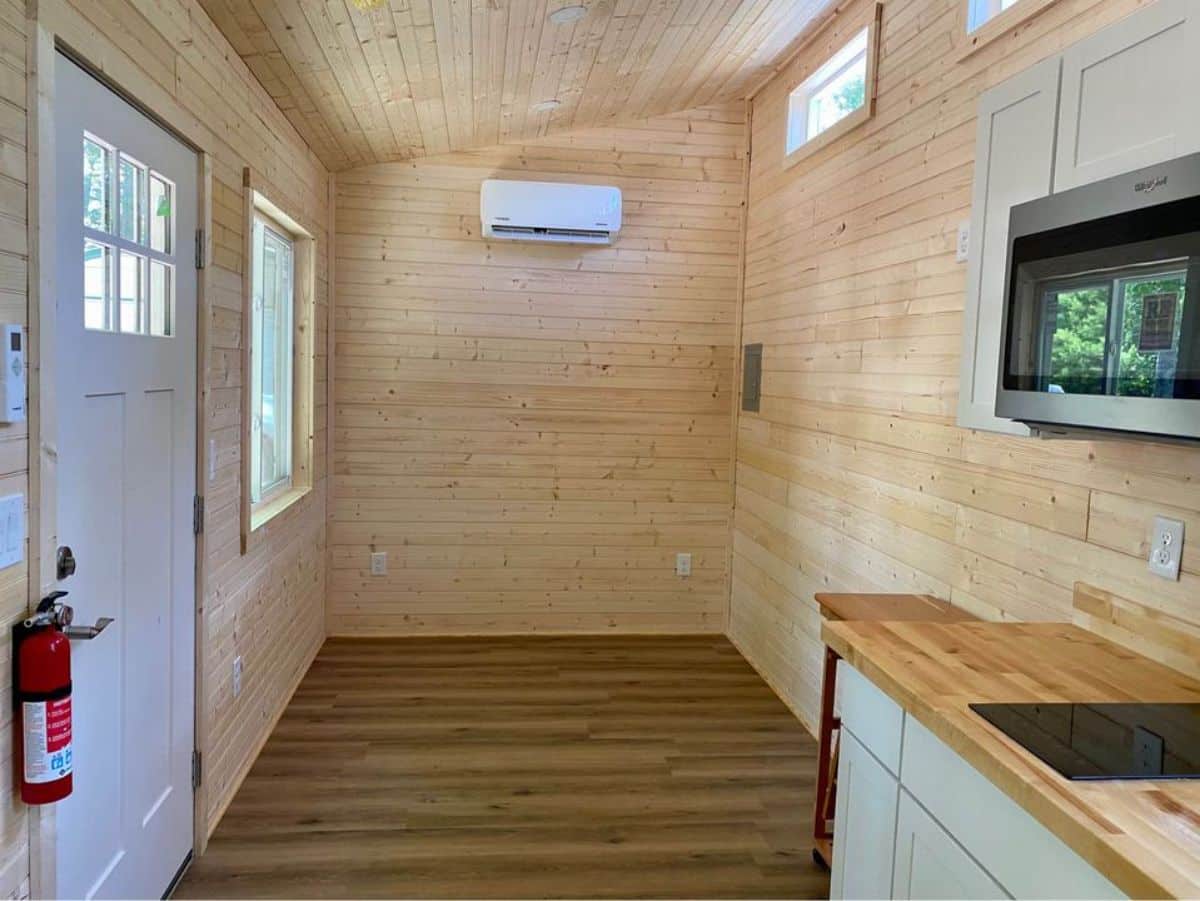 Unfurnished living cum sleeping area of 24’ Tiny Home Shell on Wheels has an insulated walls and floor, air-condition unit installed included in the deal
