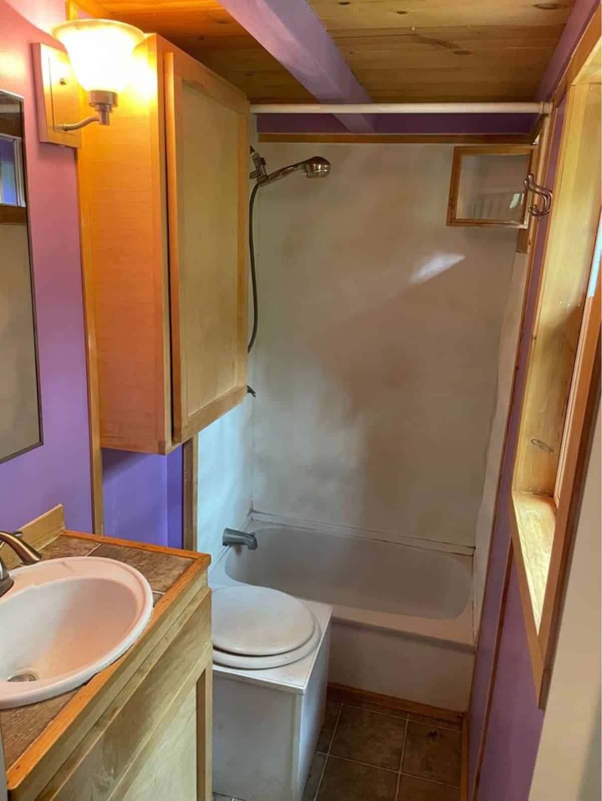 Bathtub in bathroom of 27’ Tiny House With Two Lofts