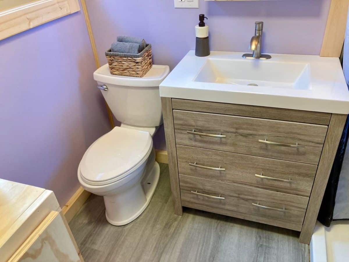 Sink with vanity and standard toilet in bathroom of 28’ Tiny Home