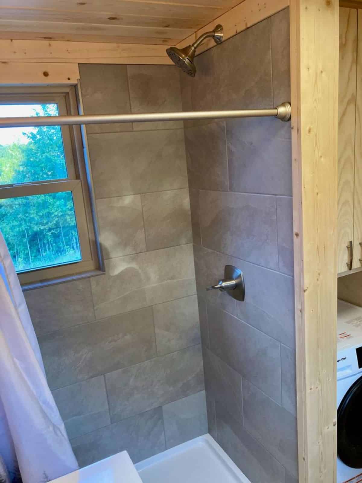 Separate shower area in bathroom of 28’ Tiny Home