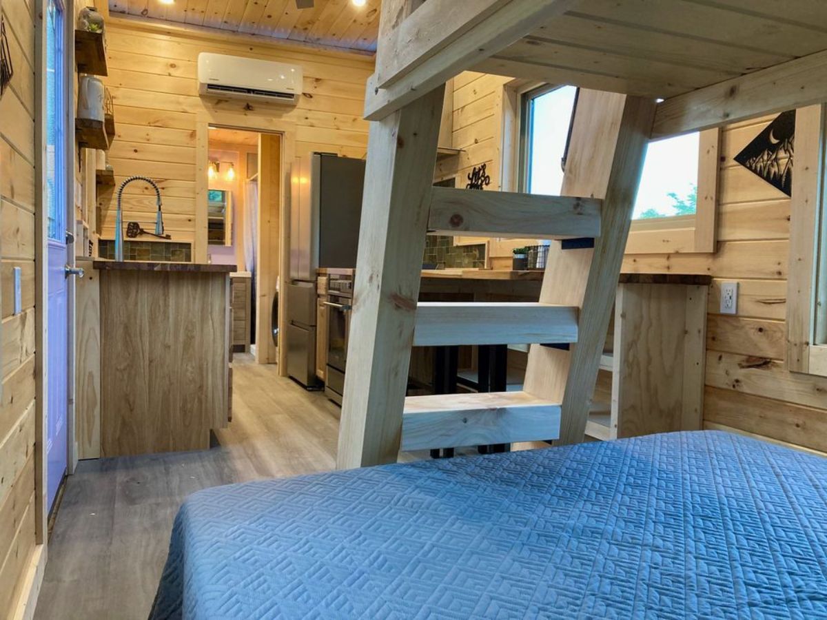 Wooden interior view of 28’ Tiny Home from bedroom