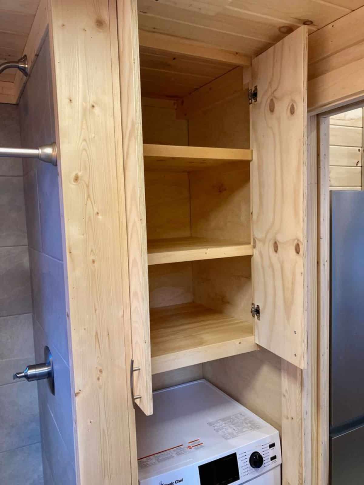 Storage cabinets in bathroom of 28’ Tiny Home