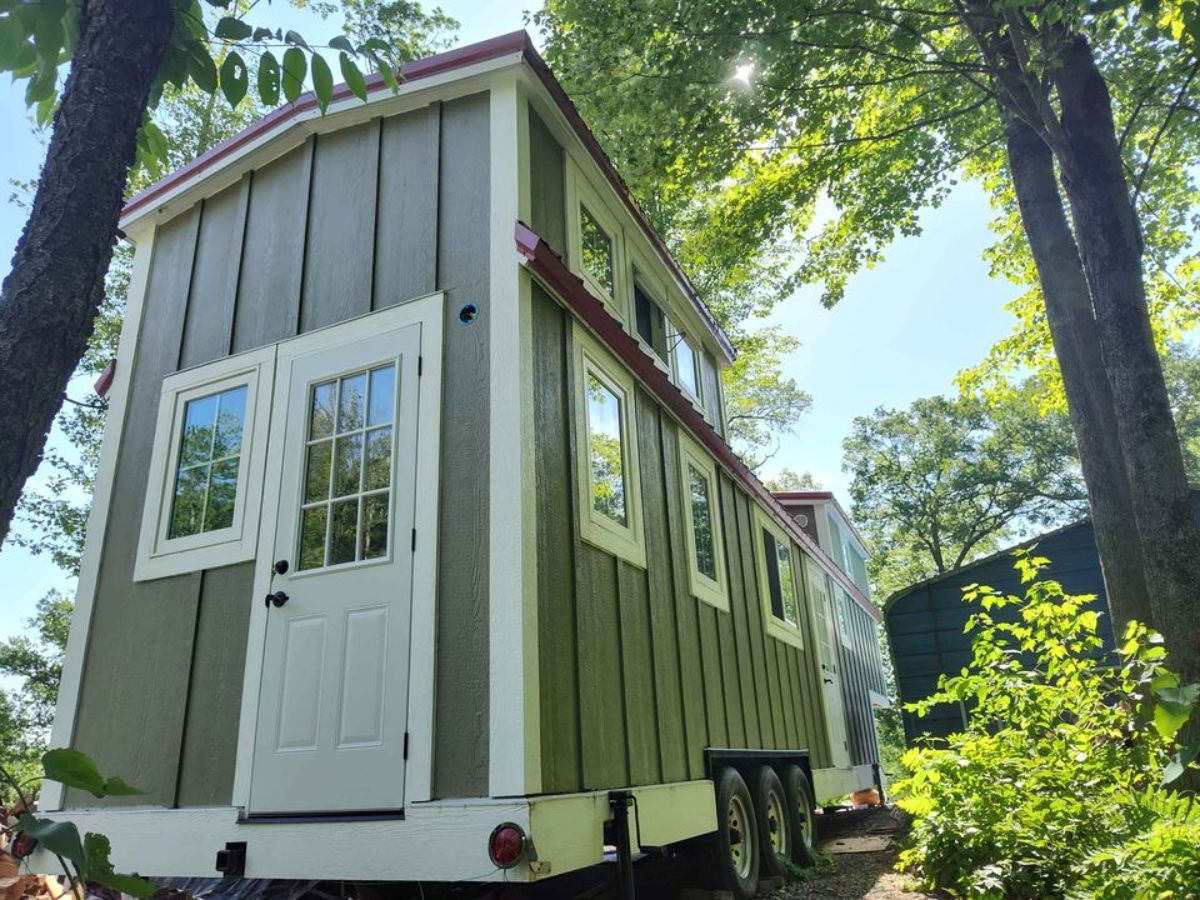 Green and white foam insulated exterior from Backside door view of 38’ Tiny House