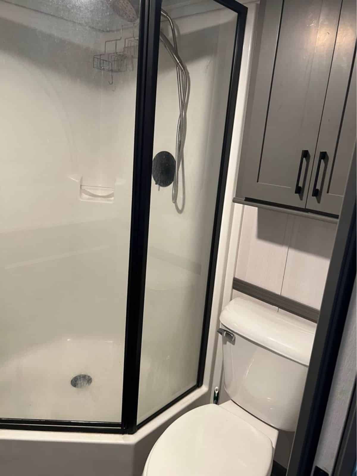 Standard toilet and separate shower area in bathroom of 399 sf Park Model Tiny House