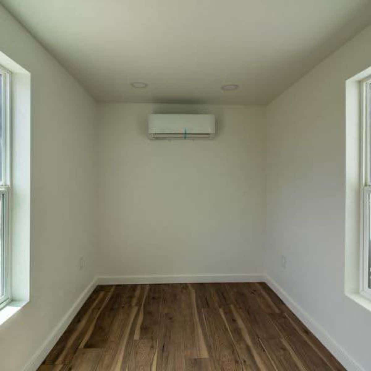Bedroom area of 40’ Shipping Container Tiny House has split air condition unit installed
