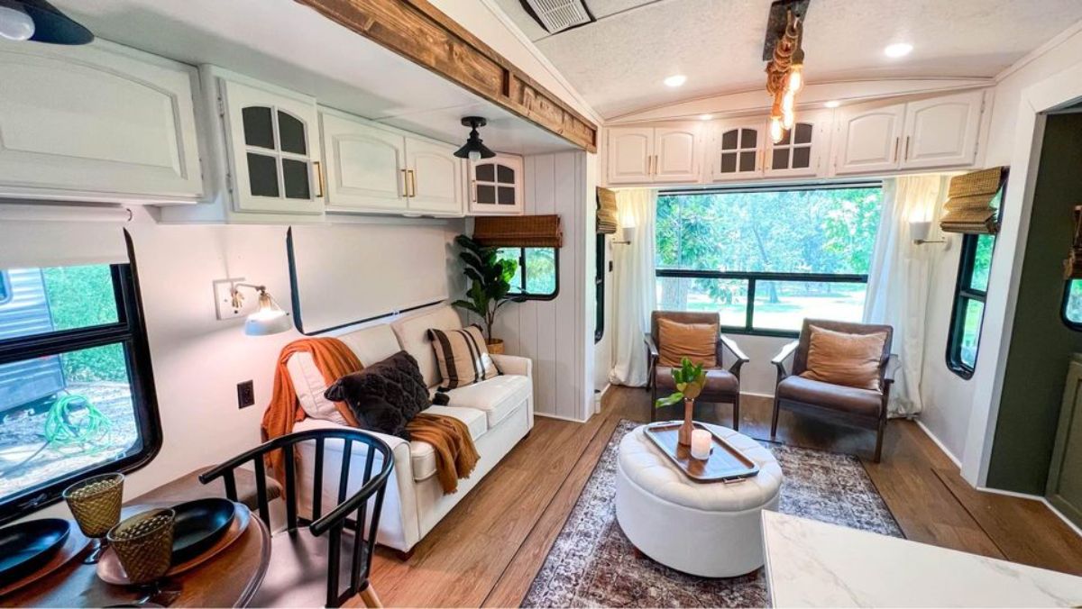 Living area of 40' Tiny House has a couch, 2 chair and a center table