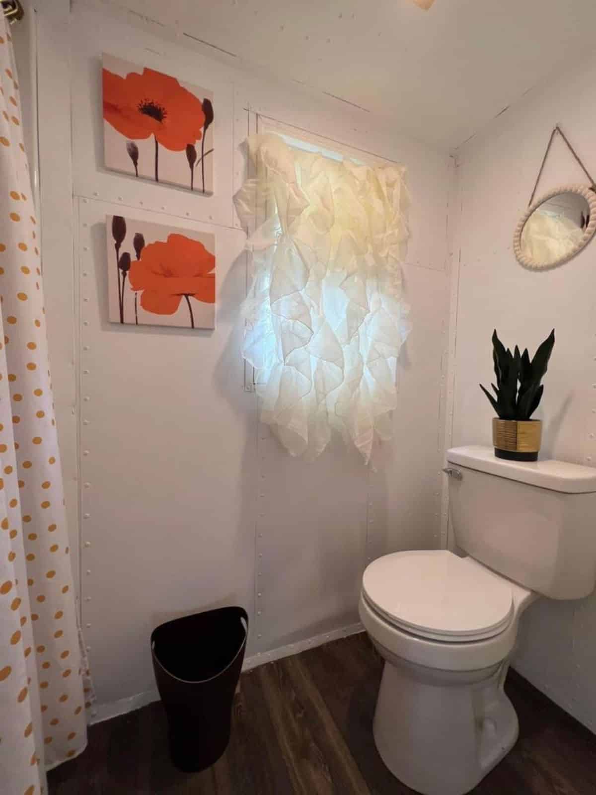 Bathroom of 16’ Turnkey Ready Tiny House has a standard toilet, shower