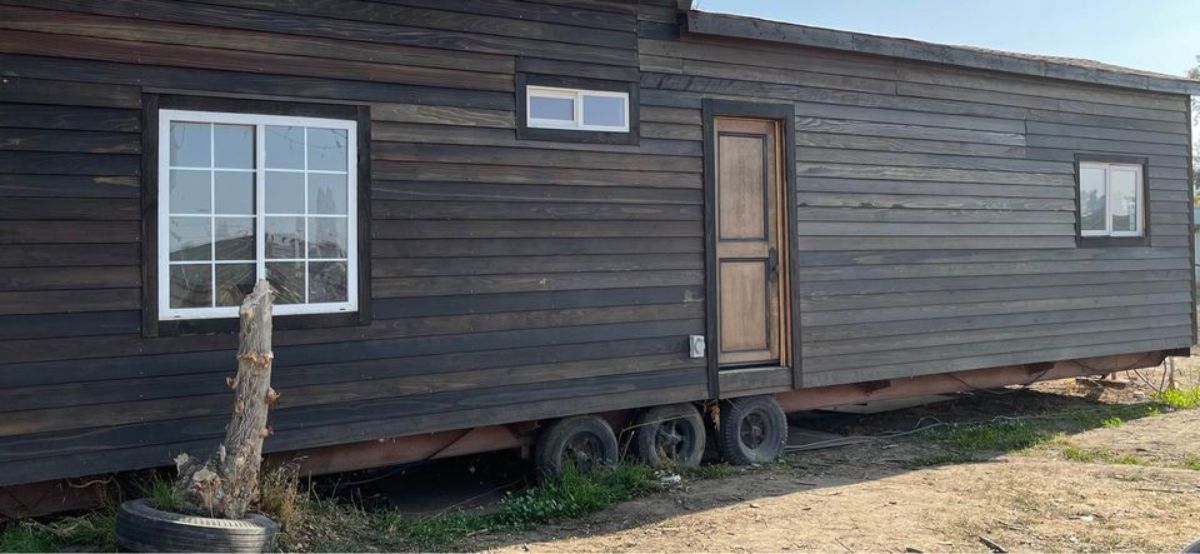 Stunning wooden exterior and main entrance view of 2 Bedroom Unfinished Tiny House