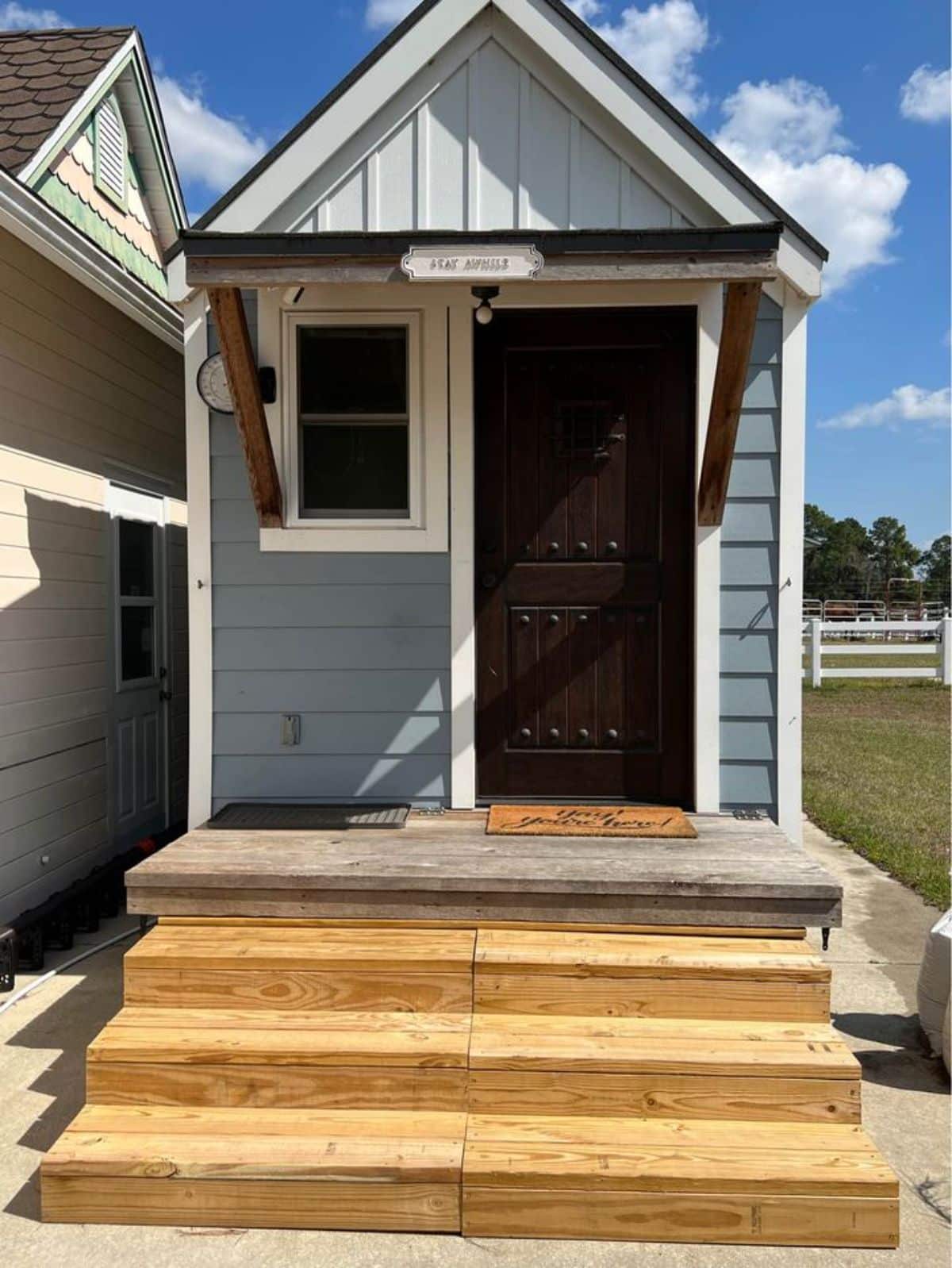 Small stairs leading to the main entrance door of 20’ Furnished Tiny Home