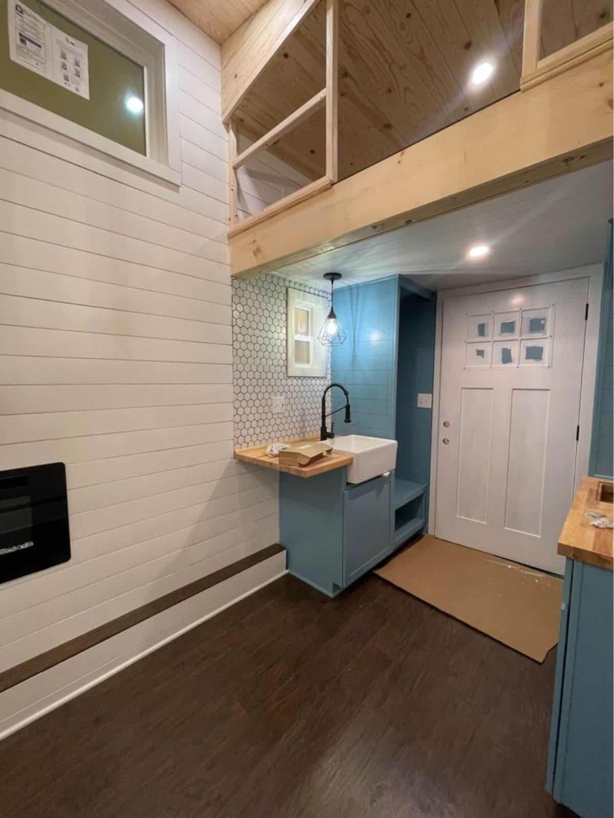 Kitchen area of 20' Modern Tiny Home is small but stylish