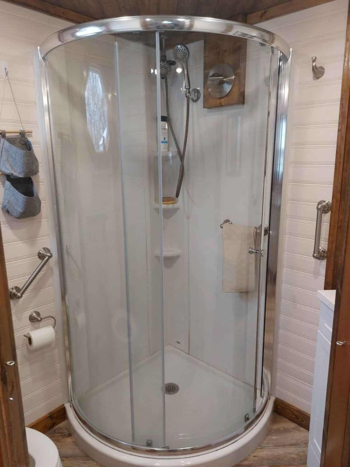 Separate shower area with glass doors in bathroom