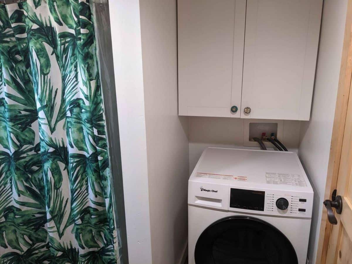 Washer and dryer combo in bathroom of 30' Custom Built Tiny Home on Wheels