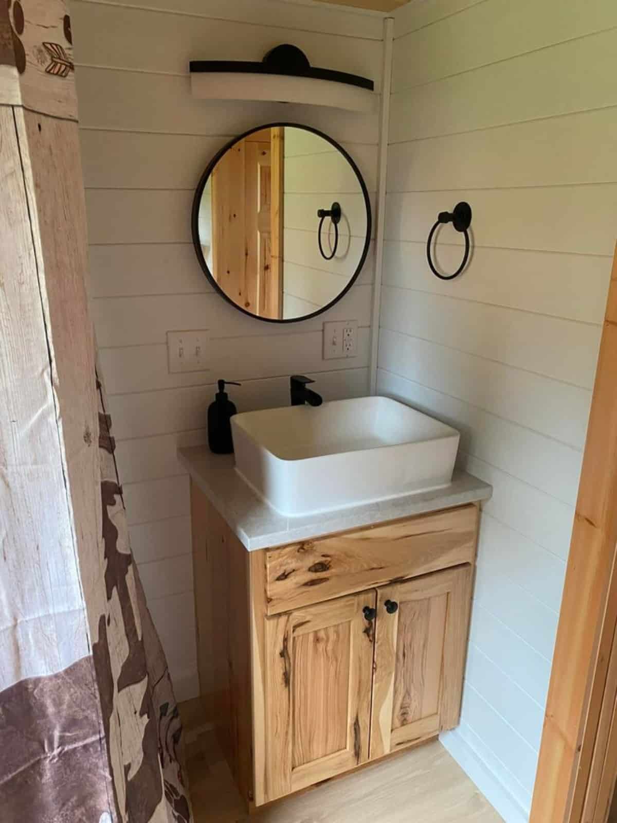Sink with vanity & mirror and shower area of 30' Custom Hickory Lodge is the Tiny Cabin