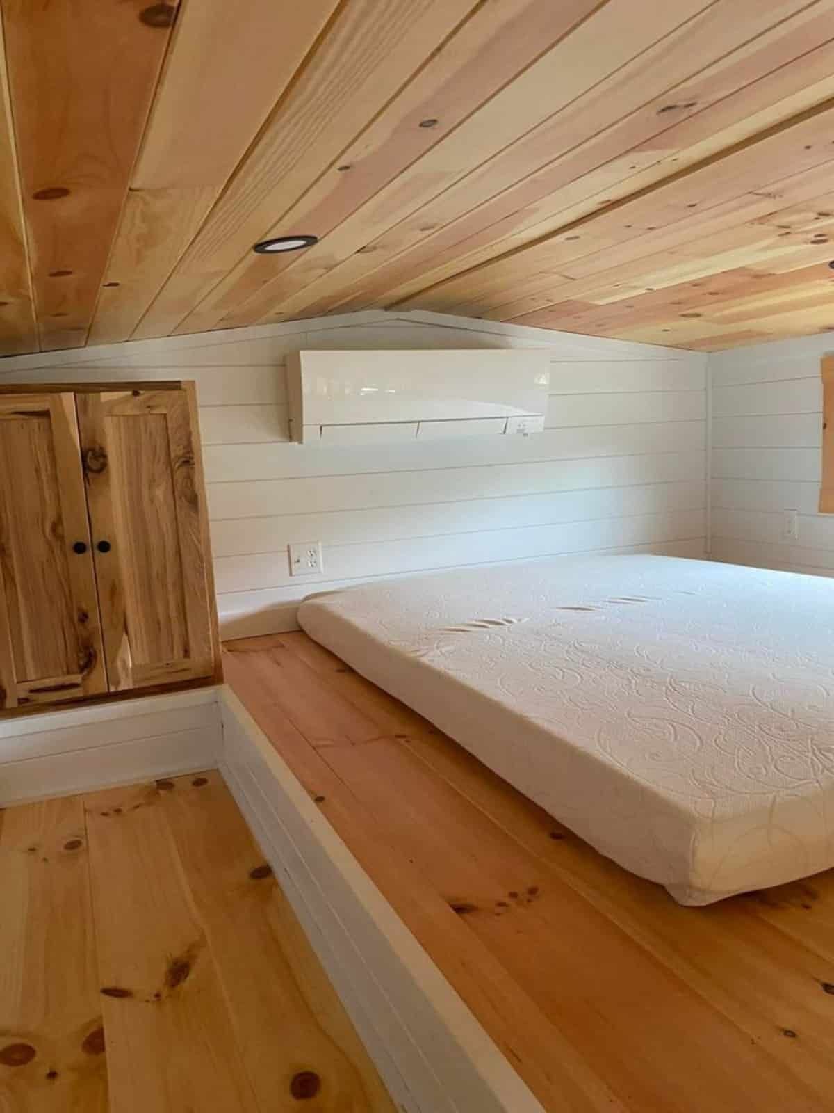 Gorgeous loft bedroom of 30' Custom Hickory Lodge is the Tiny Cabin has a queen mattress and still ample space left